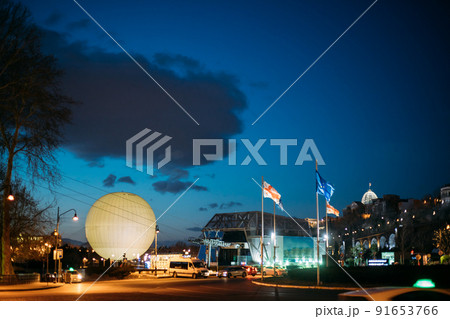 Tbilisi, Georgia. Scenic View Of Park Rike In Tbilisi, Georgia. Air Balloon Viewpoint, Cableway. Evening Scenic View Of City Center In Lighting. Official Residence Of Georgian President On Background Tbilisi, Georgia. Scenic View Of Park Rike In Tbilisi, Georgia. Air Balloon Viewpoint, Cableway. Evening Scenic View Of City Center In Lighting. Official Residence Of Georgian President On Background 91653766