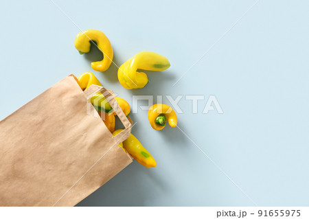 Abnormal ugly organic yellow pepper in paper bag. View from above. Abnormal ugly organic yellow pepper in paper bag. View from above. 91655975