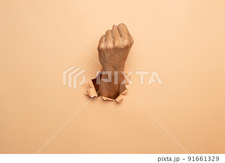 Close-up of Man hand isolated on a brown background Close-up of Man hand isolated on a brown background 91661329