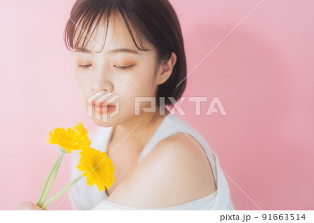 花を持つ若い女性 91663514