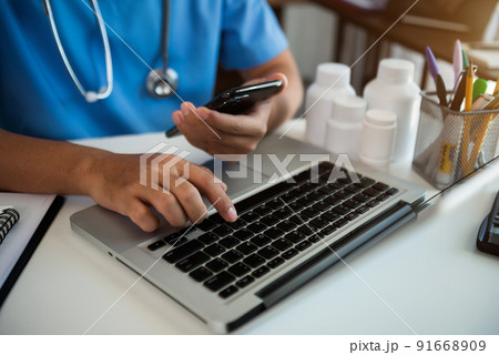 Medical Technology Concepts The doctor is working  laptop and smartphone searching information. 91668909