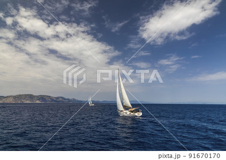 Yacht sailing at sunset during a storm. Luxury vacation at sea Yacht sailing at sunset during a storm. Luxury vacation at sea 91670170