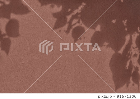 Shadow of leaves on brown concrete wall texture background Shadow of leaves on brown concrete wall texture background 91671306