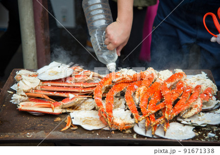 Tokyo, Japan Street in Tsukiji outer market in Ginza with closeup retail sample display of cooked red crab lobster legs white meat. Tokyo, Japan Street in Tsukiji outer market in Ginza with closeup retail sample display of cooked red crab lobster legs white meat. 91671338