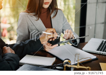 business people and lawyers discussing contract papers sitting at the table. Concepts of law, advice, legal services. in morning light. business people and lawyers discussing contract papers sitting at the table. Concepts of law, advice, legal services. in morning light. 91671745