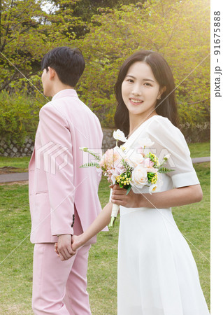 Korean Asian couple self small wedding concept in spring, talking a walk Korean Asian couple self small wedding concept in spring, talking a walk 91675888