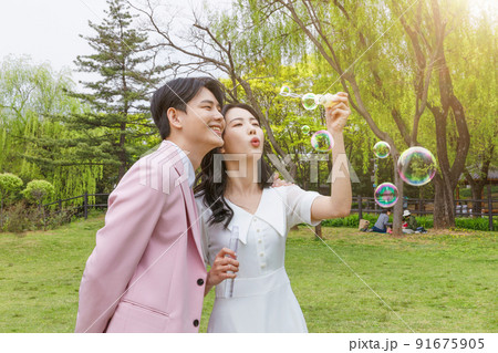Korean Asian couple self small wedding concept in spring_blowing soap bubbles 91675905