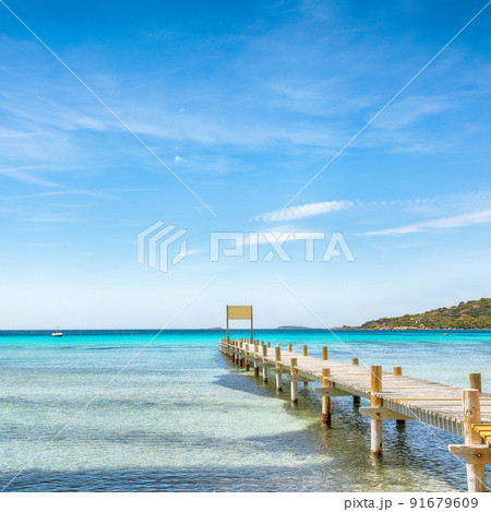 Astonishing landscape with wooden pier on Santa Giulia beach. Astonishing landscape with wooden pier on Santa Giulia beach. 91679609