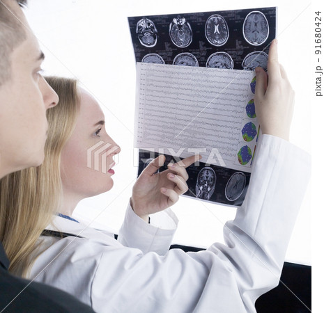 Epileptologist examines patient MRI and electroencephalogram. Concept treating epilepsy and helping people who suffer from this disease. Neurologist at work. Pathology of the brain. Seizure activity Epileptologist examines patient MRI and electroencephalogram. Concept treating epilepsy and helping people who suffer from this disease. Neurologist at work. Pathology of the brain. Seizure activity 91680424
