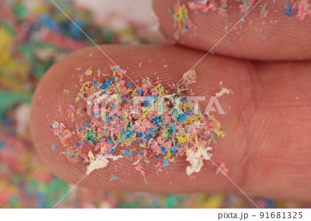 Finger close-up with traces of plastic and microplastic, environmental pollutant. 91681325