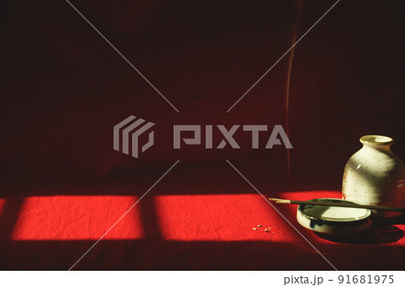 Light and shadows cast on a porcelain container and incense sticks showing the concept of meditation, mindfulness and mental wellbeing Light and shadows cast on a porcelain container and incense sticks showing the concept of meditation, mindfulness and mental wellbeing 91681975