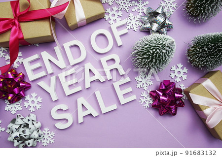 End of Year Sale alphabet letters with gift boxes, snowflake and artificial christmas tree on purple background 91683132