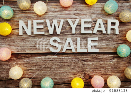 New Year Sale alphabet letters decorate with LED cotton balls on blue background 91683133