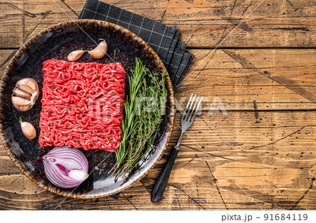 Raw Mince, minced Ground beef and lamb meat. Wooden background. Top view. Copy space Raw Mince, minced Ground beef and lamb meat. Wooden background. Top view. Copy space 91684119