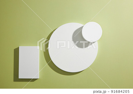 Top view of circle , square white podium ,  in green background and blank space for advertising , abstract content   91684205