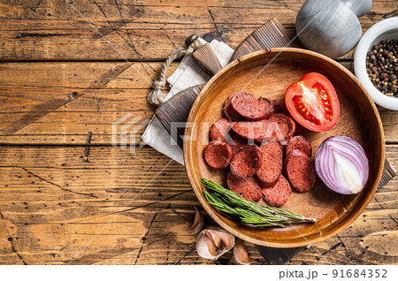 Turkish breakfast with Fried sausage sucuk on a rustic plate. Wooden background. Top view. Copy space Turkish breakfast with Fried sausage sucuk on a rustic plate. Wooden background. Top view. Copy space 91684352