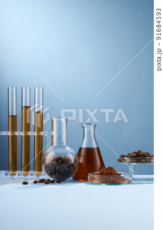 Front view of coffee decorated in transparent podium and glassware laboratory equipment light blue background 91684593