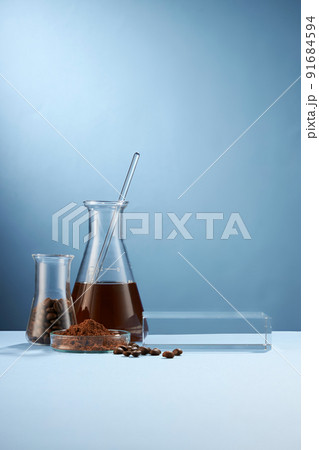 Front view of coffee decorated in transparent podium and glassware laboratory equipment light blue background Front view of coffee decorated in transparent podium and glassware laboratory equipment light blue background 91684594
