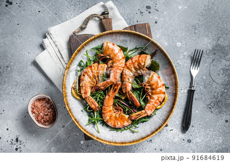 Salad with grilled Giant shrimps prawns in plate. Gray background. Top view Salad with grilled Giant shrimps prawns in plate. Gray background. Top view 91684619