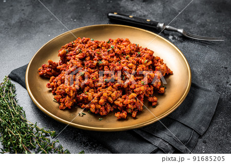 Bolognese sauce with ground beef, stewed with tomato sauce and spices. Black background. Top view Bolognese sauce with ground beef, stewed with tomato sauce and spices. Black background. Top view 91685205