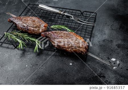 Picanha, traditional Brazilian barbecue, grilled beef meat steak. Black background. Top view 91685357