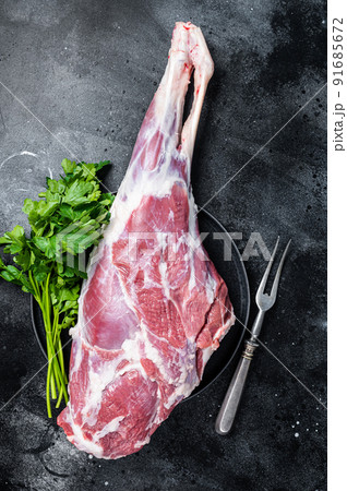 Ready for cooking raw lamb mutton leg with Thigh. Black background. Top view Ready for cooking raw lamb mutton leg with Thigh. Black background. Top view 91685672