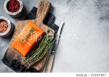 Fresh Raw salmon fillet steak on wooden board. White background. Top view. Copy space Fresh Raw salmon fillet steak on wooden board. White background. Top view. Copy space 91685867