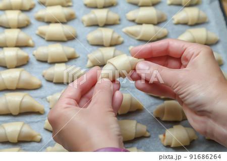 Cooking mini croissants in the kitchen at home 91686264