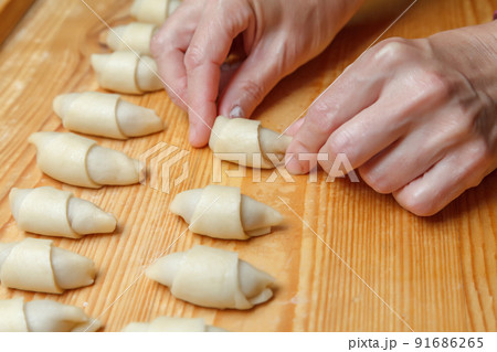 Cooking mini croissants in the kitchen at home 91686265