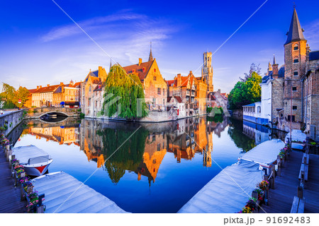 Bruges, Belgium. Sunrise on Rozenhoedkaai, old town with Belfry reflection 91692483