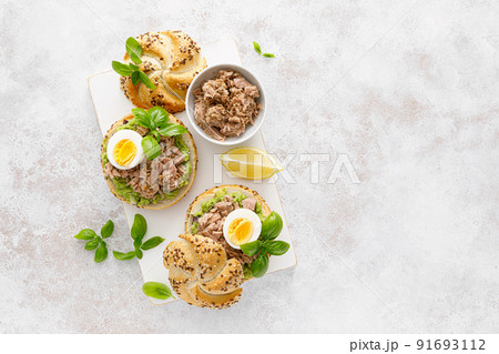 Canned tuna open sandwiches. Buns burgers with canned tuna, boiled egg and avocado 91693112