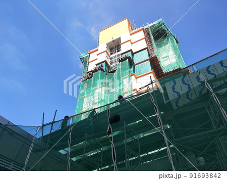SELANGOR, MALAYSIA -JULY 16, 2018: Safety netting is installed at the high rise building exterior scaffolding during construction. Its avoid building object falling directly to the ground. 91693842