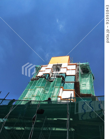 SELANGOR, MALAYSIA -JULY 16, 2018: Safety netting is installed at the high rise building exterior scaffolding during construction. Its avoid building object falling directly to the ground. 91693843
