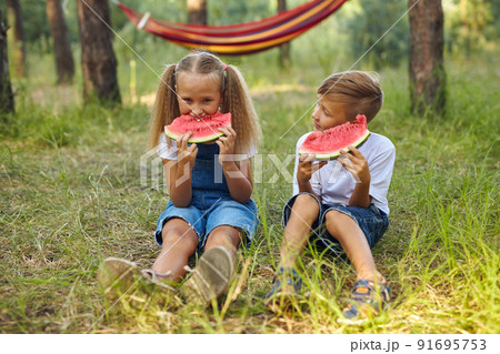 Cute kids eating watermelon in the garden. 91695753