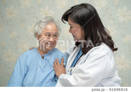 Doctor using stethoscope to checking the patient sit down on a bed in the hospital ward, healthy strong medical concept 91696816