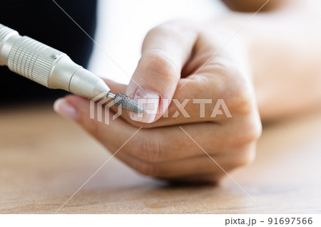 Removing shellac from the nails with fraser. Closeup. Selective focus. Removing shellac from the nails with fraser. Closeup. Selective focus. 91697566