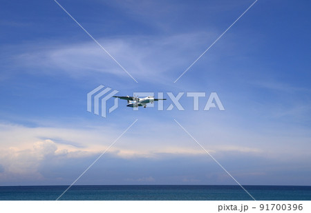 Airliner or Passenger plane Bangkok Airways ATR 72-600 landing to airport next to the beach. airplane flies extremely low over the sea beach. Airliner or Passenger plane Bangkok Airways ATR 72-600 landing to airport next to the beach. airplane flies extremely low over the sea beach. 91700396