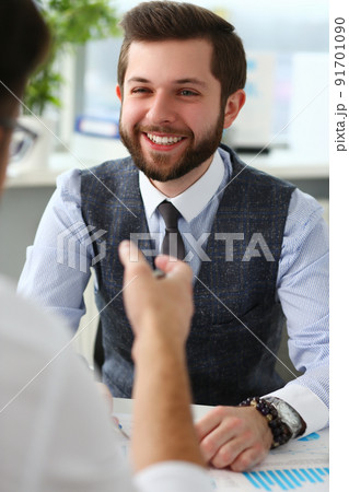 Smiling businessman communicates with business project partner Smiling businessman communicates with business project partner 91701090