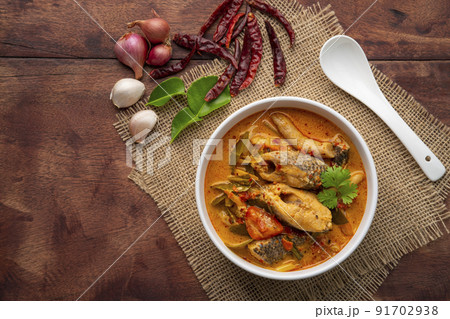 Tom yum pla,Creamy spicy soup with snake head fish tomato and mushroom,Thai hot and sour soup.Top view 91702938