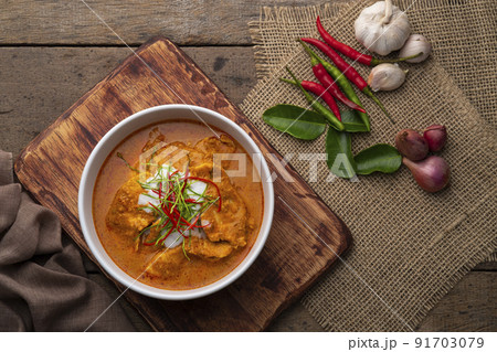 Panaeng Curry with chicken.Sliced chicken breast Meat in red curry paste and coconut milk,topping with coconut cream and Shredded kaffir lime leaves.Thai style food.Top view 91703079