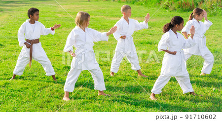 Group of kids in white kimono training 91710602