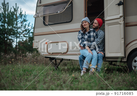Romantic couple spending time together near trailer home. Romantic couple spending time together near trailer home. 91716085
