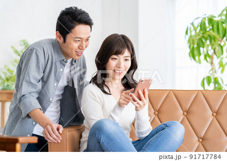 夫婦　家族　カップル　リビング　スマホ　ライフスタイル 91717784