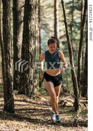 Young woman in sportswear enjoy trail running and working out in the forest Young woman in sportswear enjoy trail running and working out in the forest 91719823