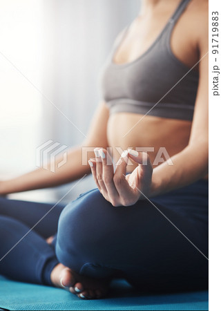 Want inner peace Meditation does the trick. Cropped shot of an unrecognizable young woman practicing yoga in her bedroom in the morning. Want inner peace Meditation does the trick. Cropped shot of an unrecognizable young woman practicing yoga in her bedroom in the morning. 91719883