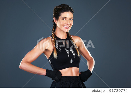 Getting fit for the betterment of my health. Studio shot of a fit young woman posing against a grey background. 91720774