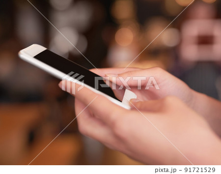 Stay in touch. Cropped shot of an unrecognizable woman using her cellphone in a coffee shop. Stay in touch. Cropped shot of an unrecognizable woman using her cellphone in a coffee shop. 91721529