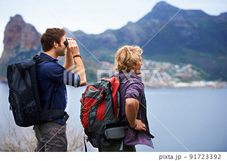 The view is unbelievable. Two male backpackers admiring a great view. The view is unbelievable. Two male backpackers admiring a great view. 91723392
