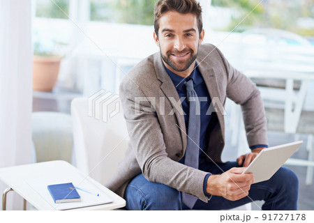Stop dreaming start doing. Shot of a businessman using his digital tablet. 91727178