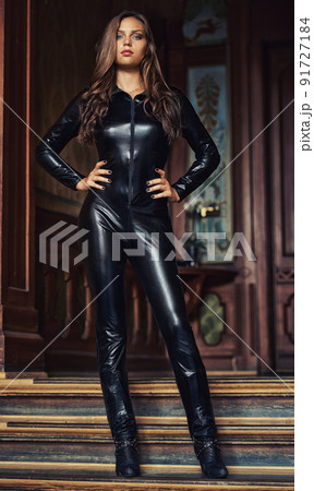 The perfect secret agent. Sexy young woman posing in a skin-tight black catsuit. 91727184